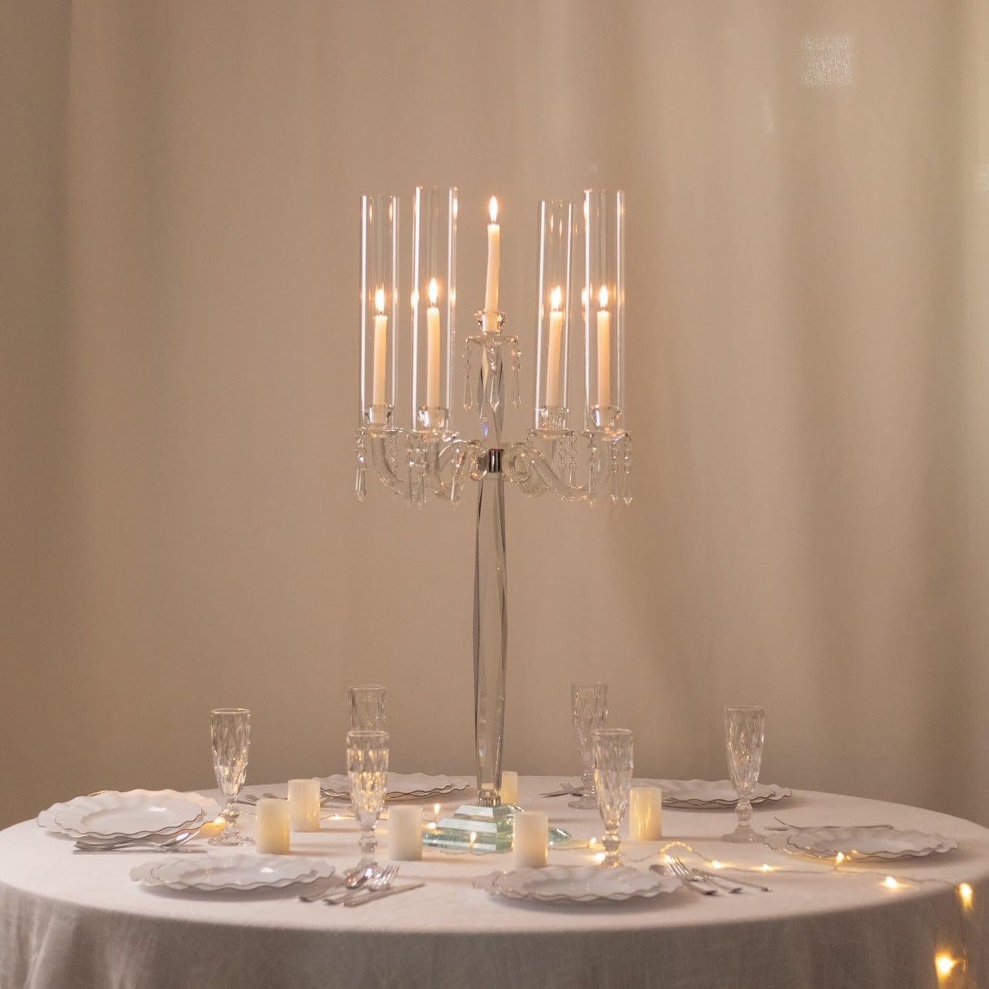 Elegant table setting with a crystal candle holder and candles on a beige background