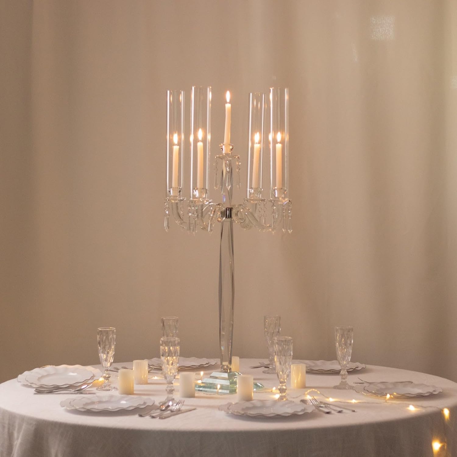 Elegant table setting with a crystal candle holder and candles on a beige background