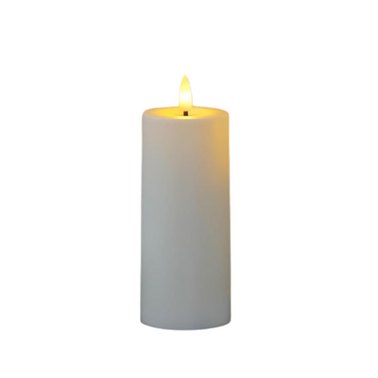 White candle with a flame on a white background