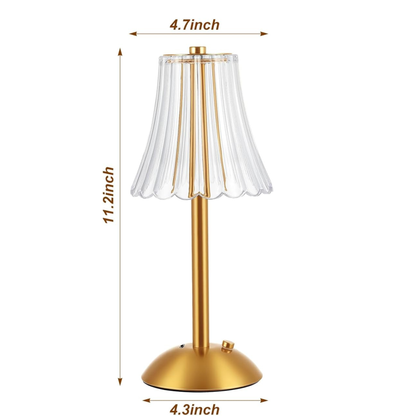Gold table lamp with clear lampshade and dimensions indicated on a white background