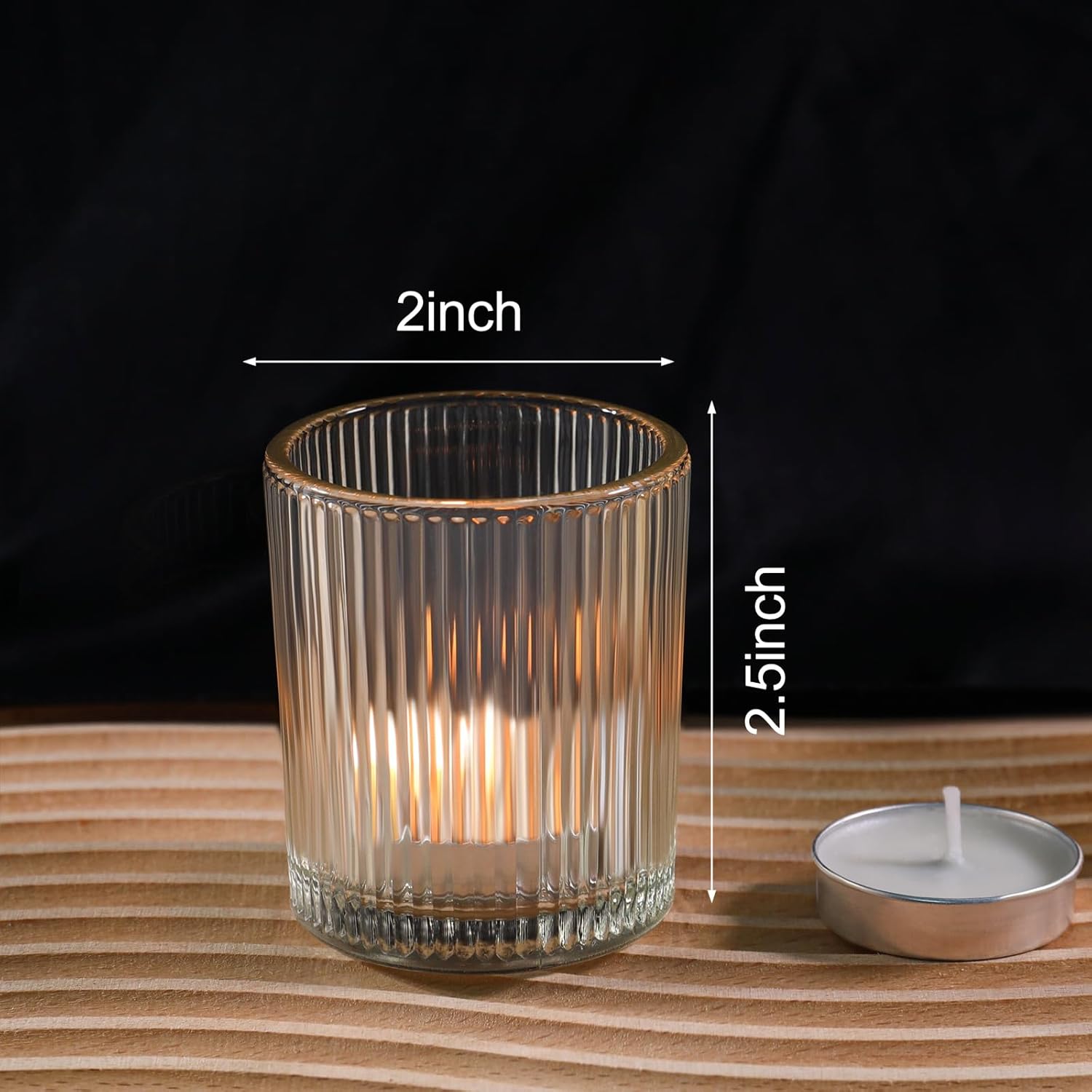 Clear glass candle holder with dimensions on a wooden surface