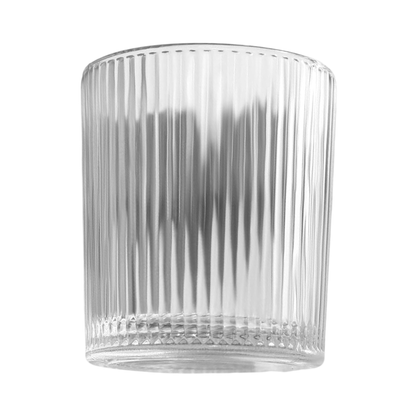 Clear glass tumbler with ribbed design on a white background